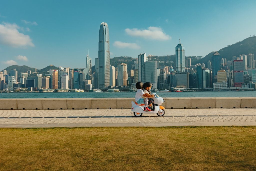 kids riding a toy motobike at West Kowloon Cultural District - Victoria Harbour